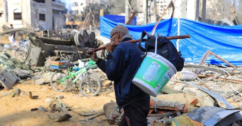 a-man-carries-possessions-through-the-ruins-of-gaza-4b8bfba5067d31837acb5a8b484fc7cf1745432026.jpg