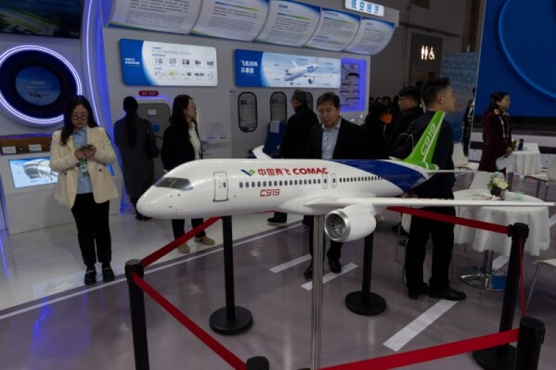 attendees-pass-by-a-model-of-the-chinese-made-c919-passenger-jet-at-the-sinochem-booth-during-the-china-international-supply-chain-expo-in-beijing-nov-79258869099392a899ceff37b892c2c61761540689.jpg