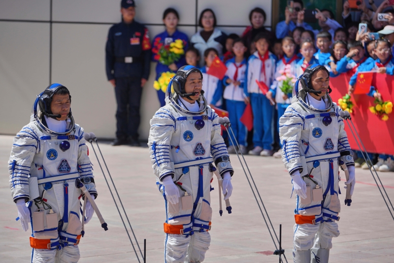 chinese-astronaut-for-the-shenzhou-20-mission-chen-dong-center-speaks-next-to-his-comrades-chen-zhongrui-right-and-wang-jie-as-they-attend-a-send-off-ceremony-thursday-april-24-2025-ae5eed642f87640dea8e57b937e1adf21763091070.jpg