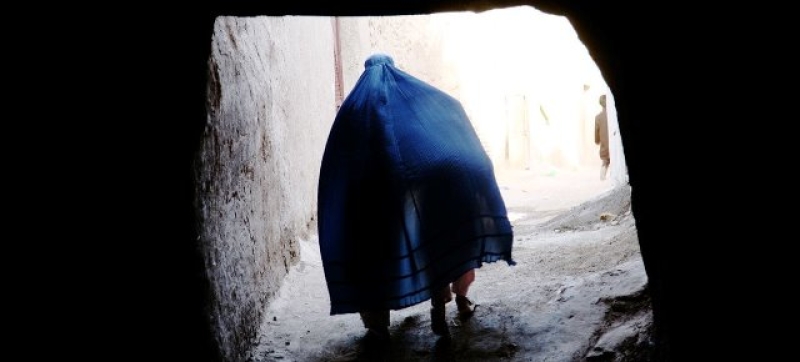 an-afghan-woman-covers-a-child-under-her-borqa-while-passing-through-a-tunnel-in-herat-afghanistan-12fa9c1307ae7b45bff64ae93632fb1d1788348922.jpg