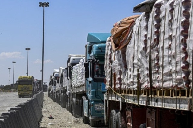 egyptian-trucks-carrying-humanitarian-aid-bound-for-the-gaza-strip-queue-outside-the-rafah-border-crossing-on-the-egyptian-side-on-march-23-2024-0562e4a66d51502af1566e9ae691883c1739121771.jpg